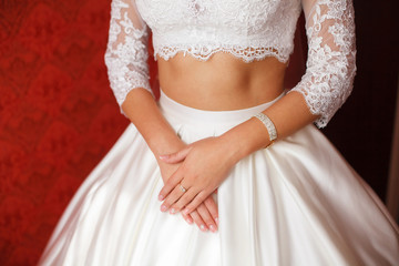 Young bride in wedding dress. Women's hands, closeup
