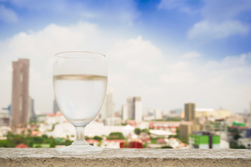 Glass of water placed on the building in the morning.