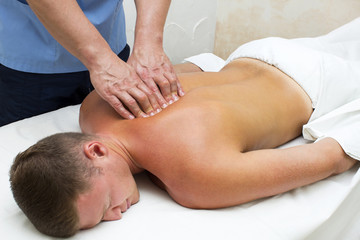 Fototapeta na wymiar young man on wellness treatments sports massage