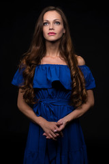 Fototapeta premium beautiful woman wearing blue dress on black background
