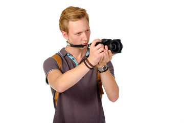 Young man traveler taking pictures by dslr camera isolated on white