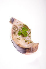 a piece of fish on a white background, photo studio, isolated, herbs, meal