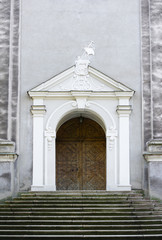 Door and entrance into old historical building that was made in late austrian baroque style. Portal is decorated