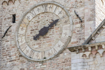 Fototapeta na wymiar Clock and tower to Church of Assisi, Umbria. Italy. August 17, 2016