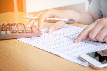 Closeup Hands pointing calculator and discussing on stock market