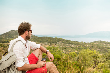 Tourist man taking a break while mountain trip