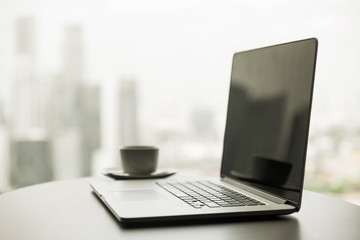 close up of laptop and coffee cup on office table