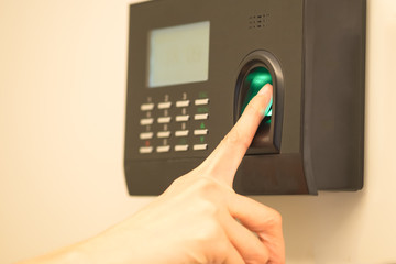 Woman's finger print scan for enter security system