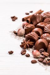 Delicious chocolate candies on wooden background