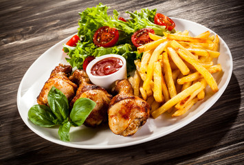 Roast chicken legs with chips and vegetables 