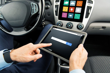 close up of man with tablet pc in car