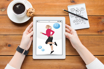 close up of woman with fitness app on tablet pc