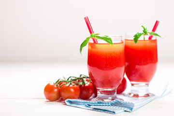 Tomato Juice and Fresh Tomatoes on a White Wooden Background