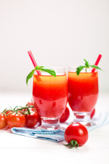 Tomato Juice and Fresh Tomatoes on a White Wooden Background