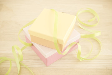 Gift wrapping for a holiday celebration, birthday or surprise party. Preparation of present with ribbon, box and decoration on table. Festive package material.