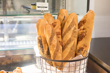 French baguettes in metal basket in bakery
