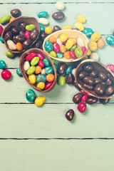 Chocolate Easter eggs and rabbit , on wooden background