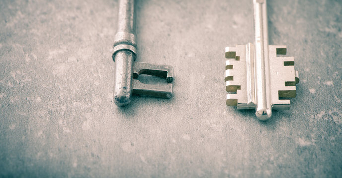 New and old key in close-up. Concept image of new property, buying an estate or home security.