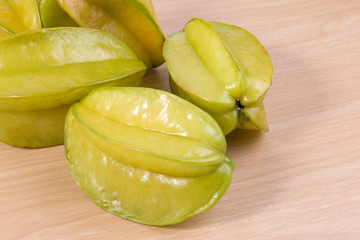 Star apple or Averrhoa carambola on wooden table. Fresh star apple fruit on table.