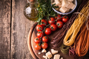  Vegetable color Pasta, oil,tomatoes,cheese on wooden table. italian food