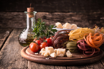  Vegetable color Pasta, oil,tomatoes,cheese on wooden table. italian food
