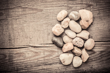 Stones on wooden background, concept of harmony and tranquility. Decoration with stone pebbles as natural design backdrop with copy space.