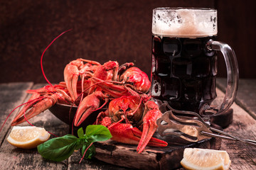 boiled crawfish and beer on a wooden background