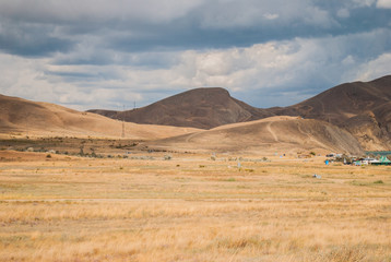 Karadag National park near Koktebel Crimea with calm lagoon and clear water and coast / Sea and mountains against the sky / Sunset on a sea beach with fantastic sky. Sunset light reflection