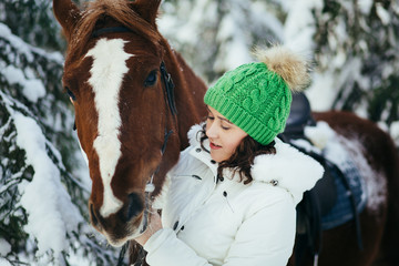 beautiful girl and horse in winter