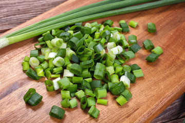 fresh green chopped onion on kitchen board