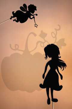 Fairy Godmother and Cinderella shadow puppet and the shade of the giant pumpkin.