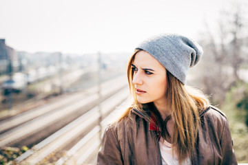 Half length of young beautiful caucasian blonde hair woman outdoor in the city, overlooking pensive - thoughtful, serious, thinking future concept