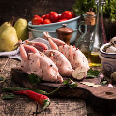 Fresh organic quails on vintage wooden table, healthy food