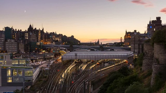 Beautiful sunset above the skyline of Edinburgh - Scotlands capital. Moon is setting above the Edinburgh Castle.