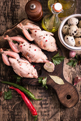 Fresh organic quails on vintage wooden table, healthy food