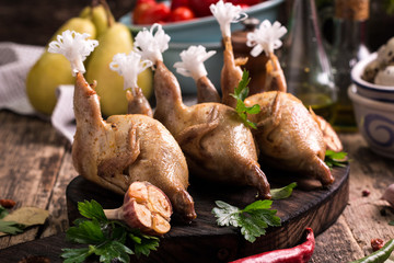 Fresh organic quails on vintage wooden table, healthy food