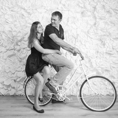 Black and white image of happy couple in love sitting on retro b