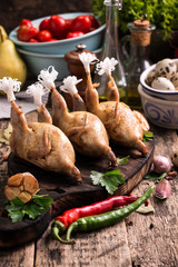 Fresh organic quails on vintage wooden table, healthy food