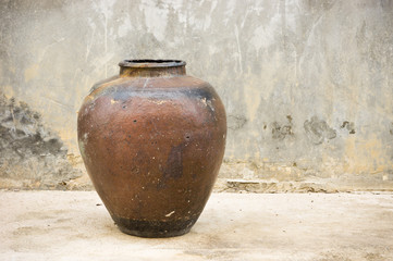 old pottery water jar with grunge wall