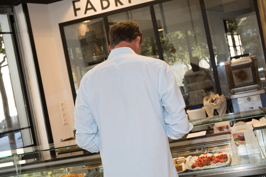 Man buying some cakes in a pastry shop