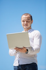 Happy business man looking to his laptop