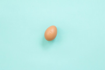 Broken chicken eggshell on blue background.