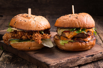 Tasty grilled burger with lettuce and mayonnaise ,on a rustic wooden table