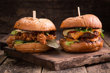 Tasty grilled burger with lettuce and mayonnaise ,on a rustic wooden table