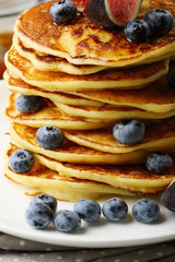 Pancakes with blueberries and maple syrup closeup