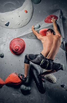 Man Climbing On An Indoor Climbing Wall.