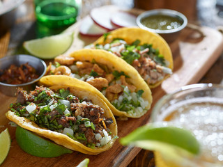 mexican street tacos in yellow tortilla with beef and pork