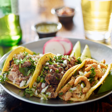 authentic mexican street tacos on plate with beef and pork