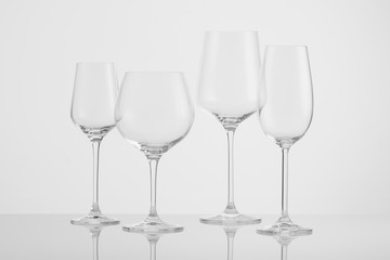 several empty wine glasses on a white background