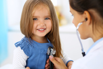 Doctor examining a little girl by stethoscope